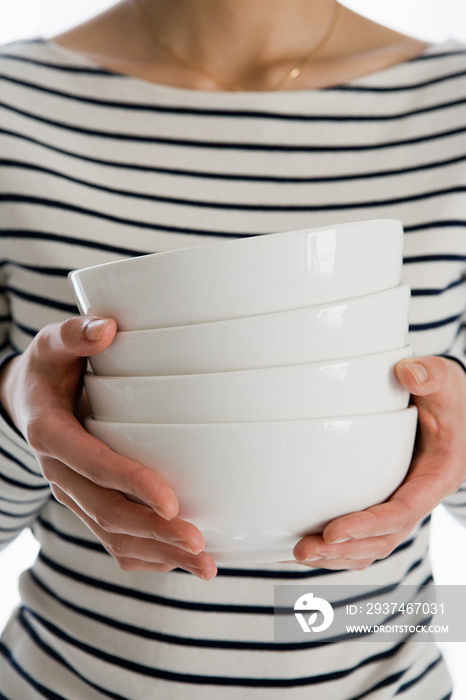 Woman holding four bowls