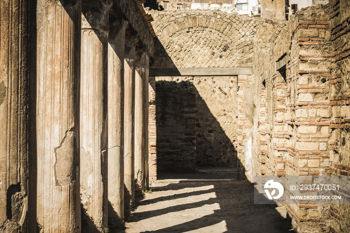 Ancient city Ercolano ruines with columns and geometrical shadows coridor