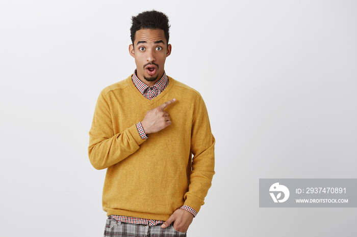 OMG, have you heard shocking news. Portrait of stunned good-looking dark-skinned guy with afro hairs