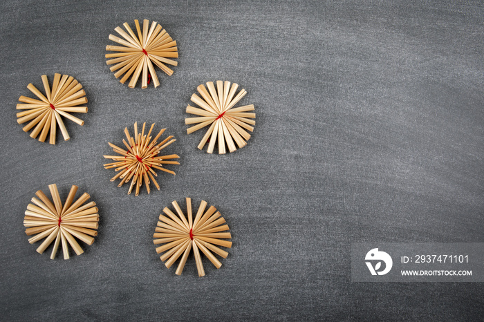 Straw Christmas decorations. black chalk board background