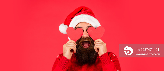 new year shopping discounts. mature man with heart cards red background. bearded santa claus in hat.