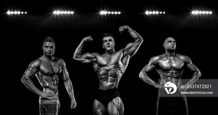 Sport wallpaper and motivation concept. Strong athletic bodybuilder at gym on black background. Fitn