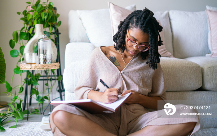 Young woman journaling in her home