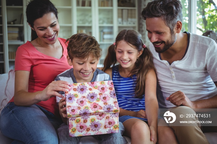 Family opening the surprise gift  in living room