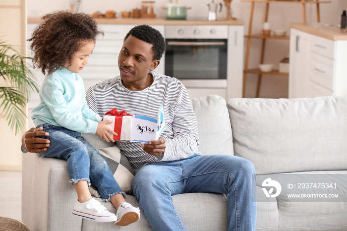 Cute African-American girl greeting her dad on Fathers Day