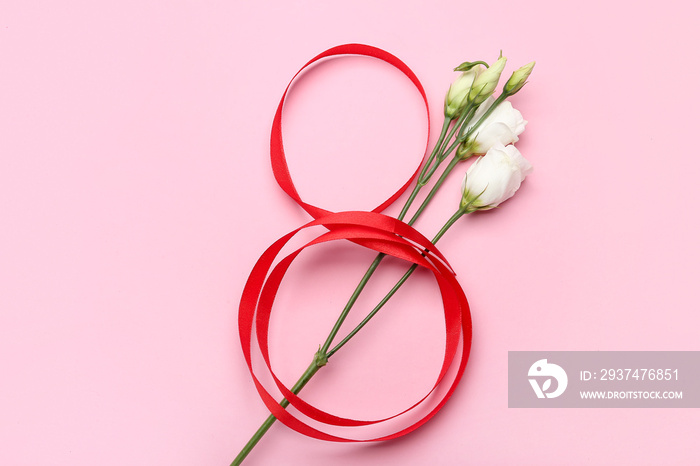 Figure 8 made of ribbon and flowers for International Womens Day celebration on pink background