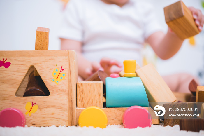 Asian child building playing toy blocks wood