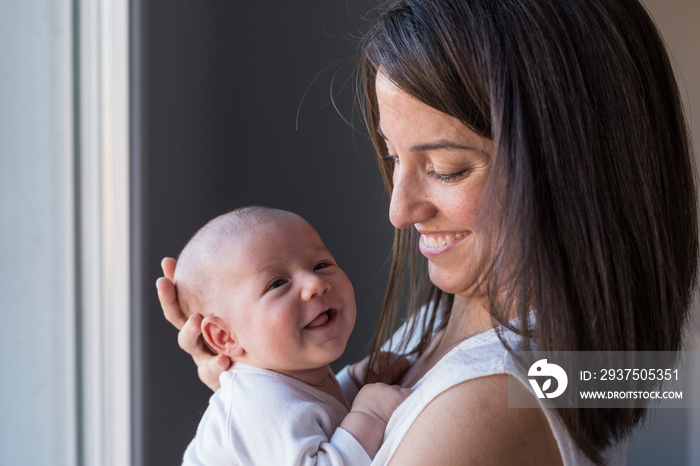 happy mother with her baby girl at home. Lifestyle indoors and family love concept