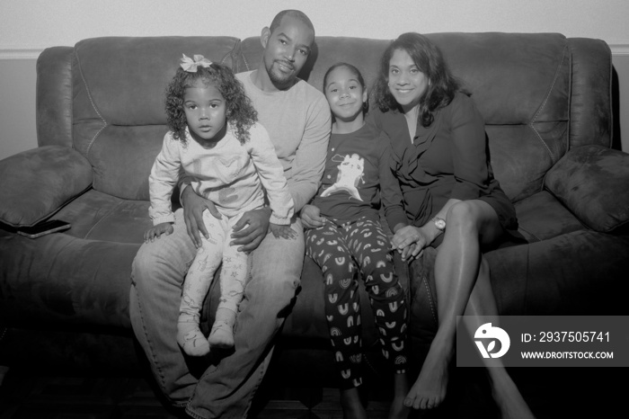 family  sitting on sofa