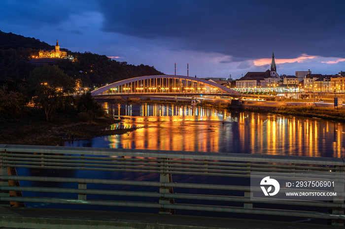 Night city scene with bridge, river reflection and nice view point