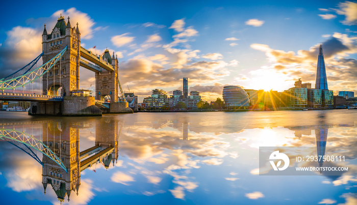 Sunset panorama of Tower Bridge with reflections in London, UK