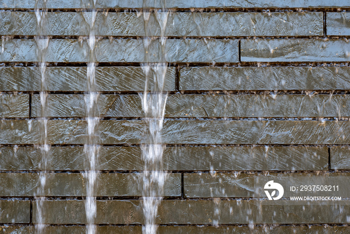 Stone wall water feature, with blurred water and rock bricks, as a background