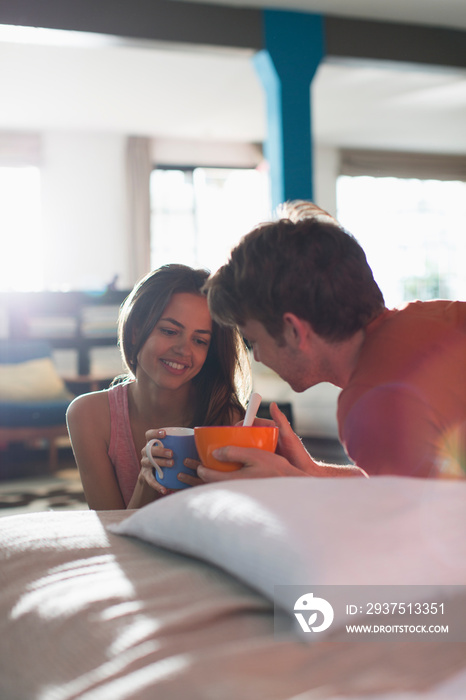 Young couple enjoying breakfast in apartment
