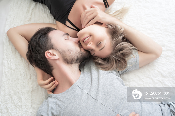 Young couple kissing in the bed .loving couple in bedroom