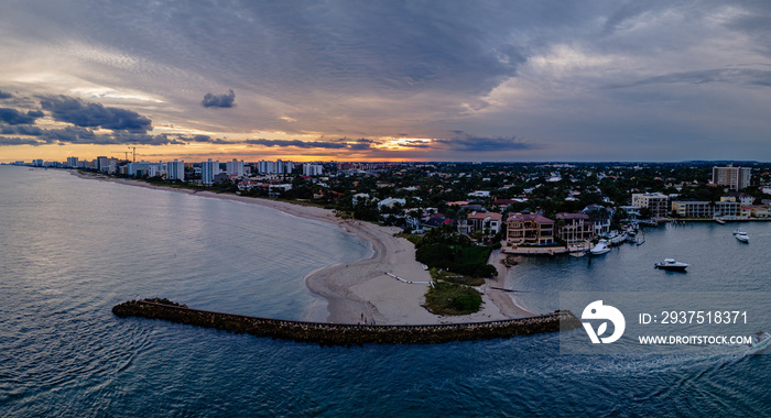 aerial drone of sunset over city with beach and ocean. clouds in sky with empty space. Pompano Beach