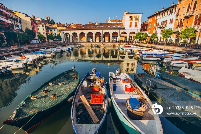 old harbour full of boats in Desenzano del Garda. Brescia, Lombardy, Italy. City Centre of Desenzano