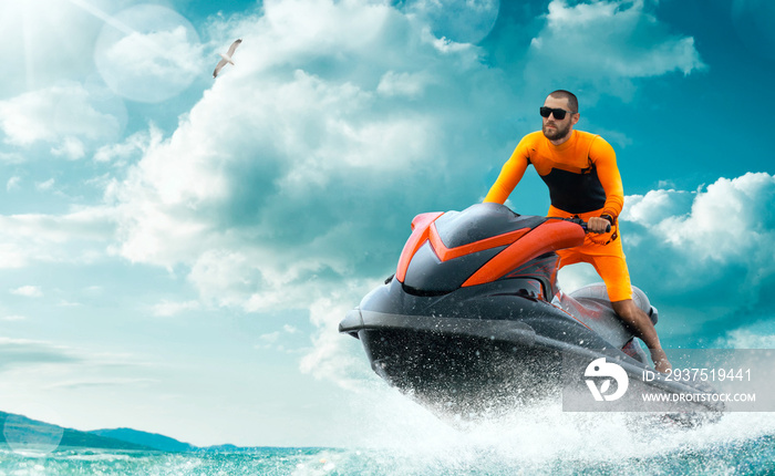 Young Man on water scooter, Tropical Ocean, Vacation Concept. Jet Ski. Sea.