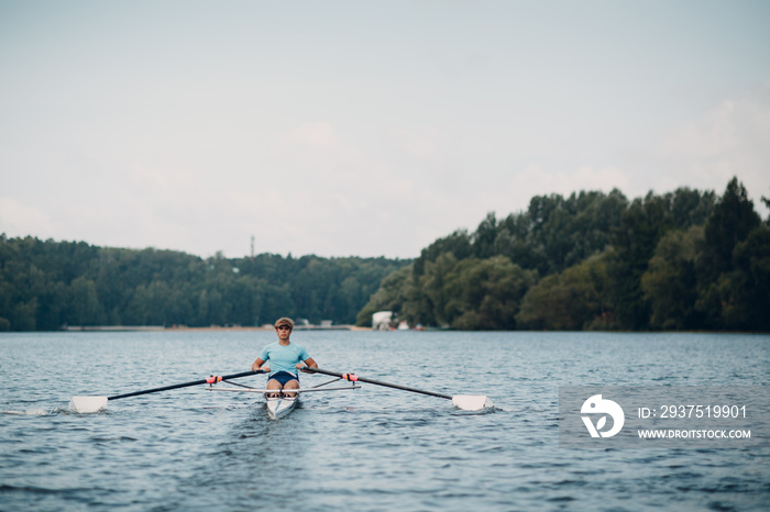 Sportsman single scull man rower rowing at competition boat regatta. Olympic games sport