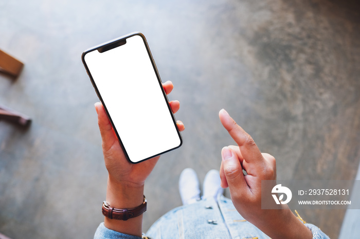 Top view mockup image of a woman holding black mobile phone with blank white screen