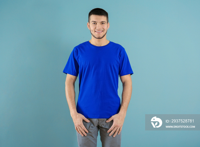 Young man in stylish t-shirt on color background. Mockup for design