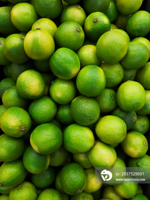 Lime citrus fruits background. Juicy green tropical lime fruit. Image green limes