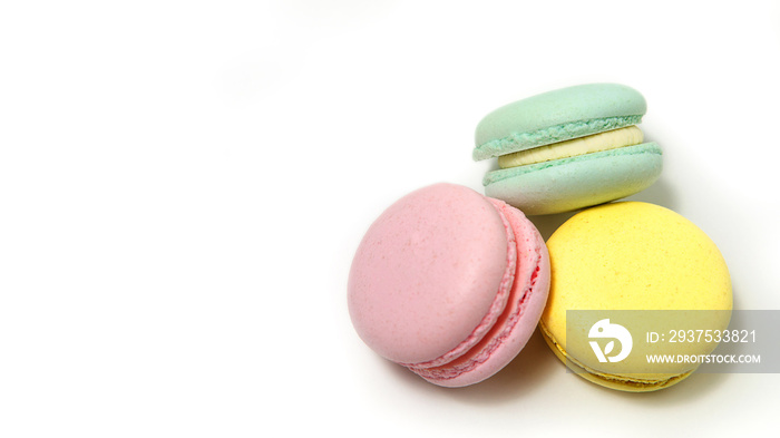 Almond cookies, in pastel colors on a white background. Traditional French multicolored dessert, clo