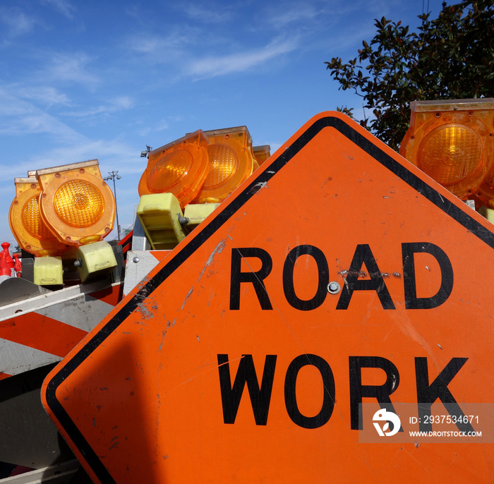 road work sign with traffic barricades