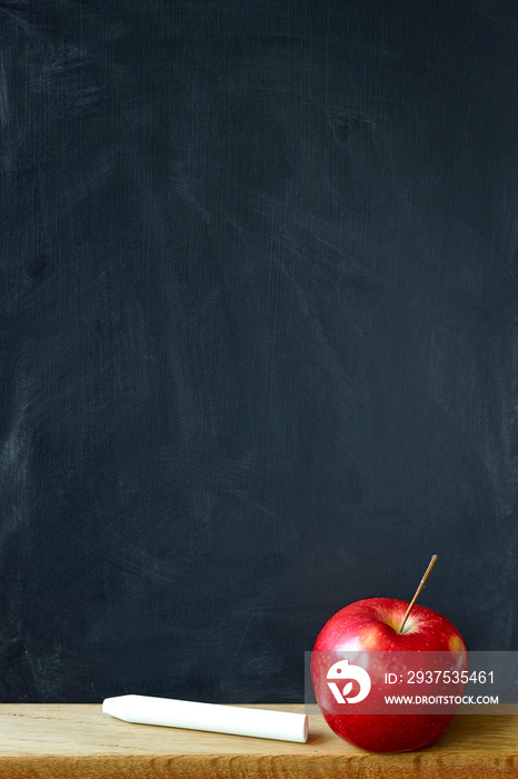 Close-up black chalk board in chalk stains chalk board and red apple, selective focus, copyspace