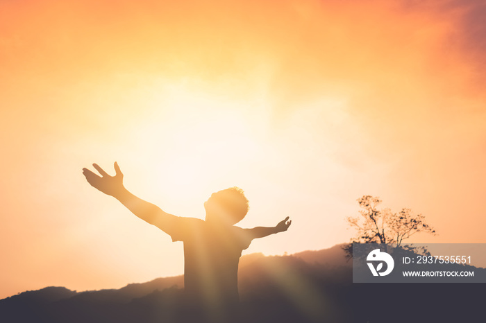 Copy space of man rise hand up on top of mountain and sunset sky abstract background.