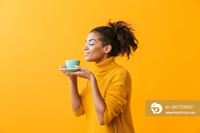 Cheerful african woman wearing sweater holding cup