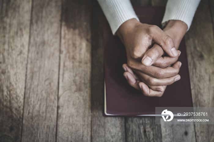 Hand of woman while praying for christian religion, Casual woman praying with her hands together ove