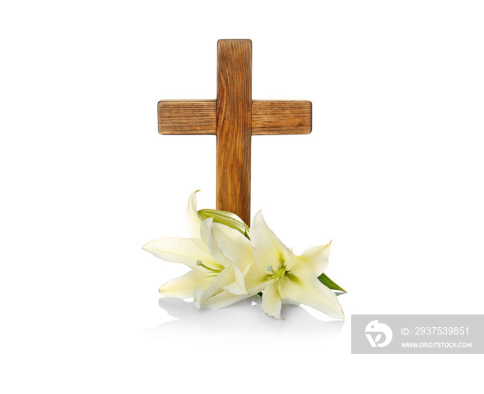 Wooden cross and lily on white background