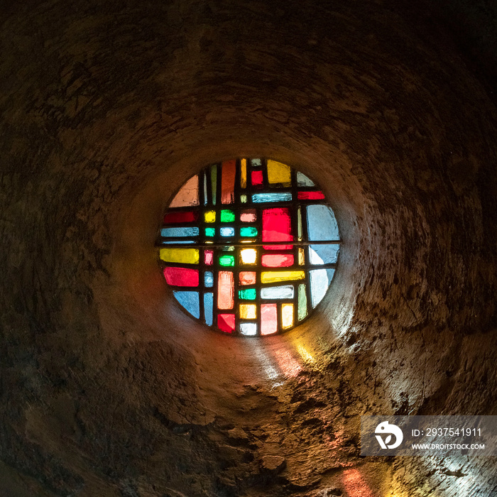 Colored stained glass window of an old chapel of Le Puy en Velay