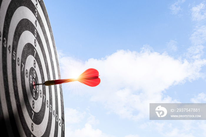 Red arrow dart hit to center of target board with cloud sky background. Business investment target c