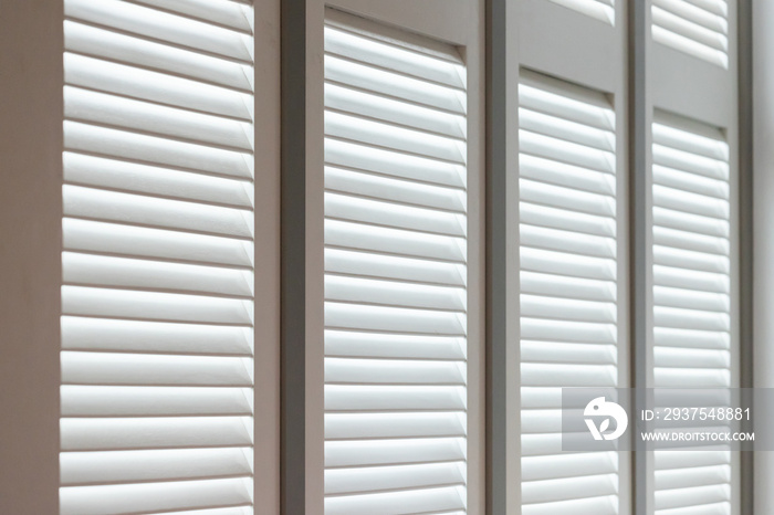 white wooden louver window decoration for vintage style. white wooden shutter with light and shadow.