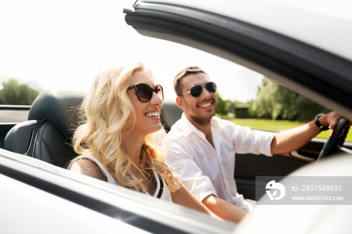 leisure, road trip, dating, couple and people concept - happy man and woman driving in cabriolet car