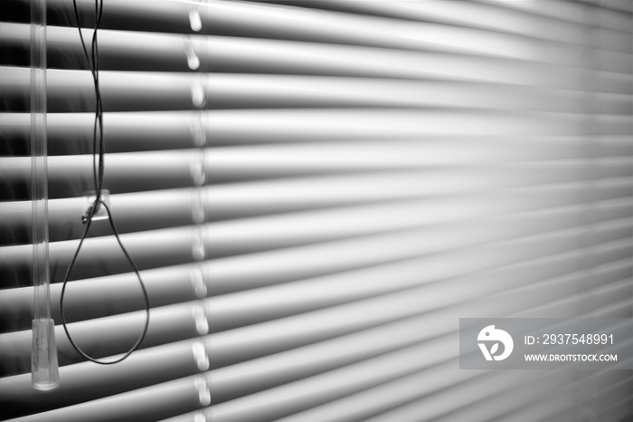 Closed shutters and rope. Jalousie background. Blinds bw