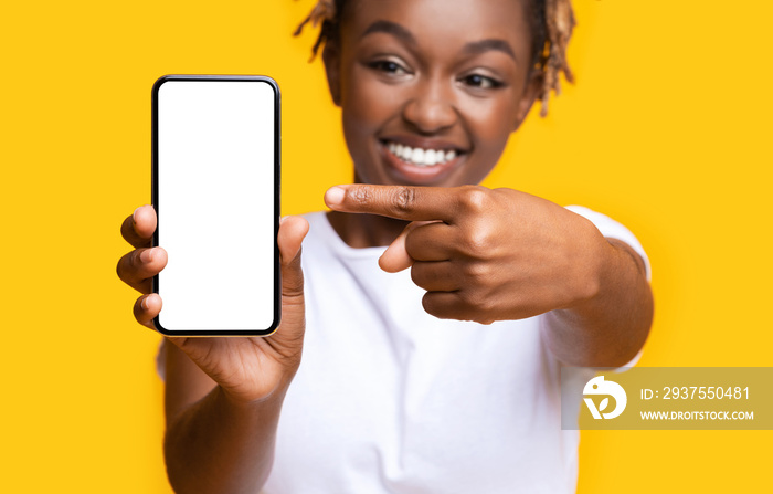 Excited african lady showing smartphone with white screen