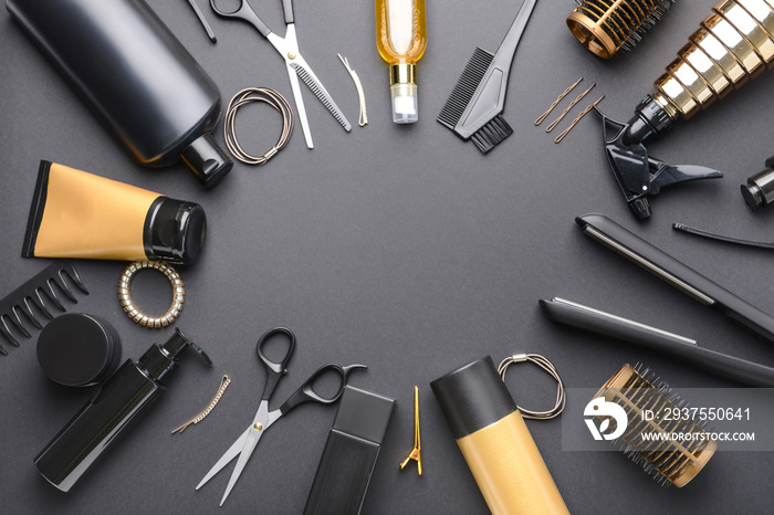 Frame made of hairdresser tools and accessories on dark background