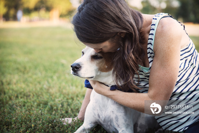 Woman lying on grass with dog