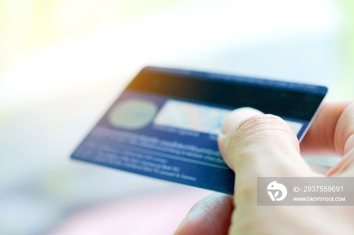 Hand of woman holds her credit card bank pay to shop for her credit card.