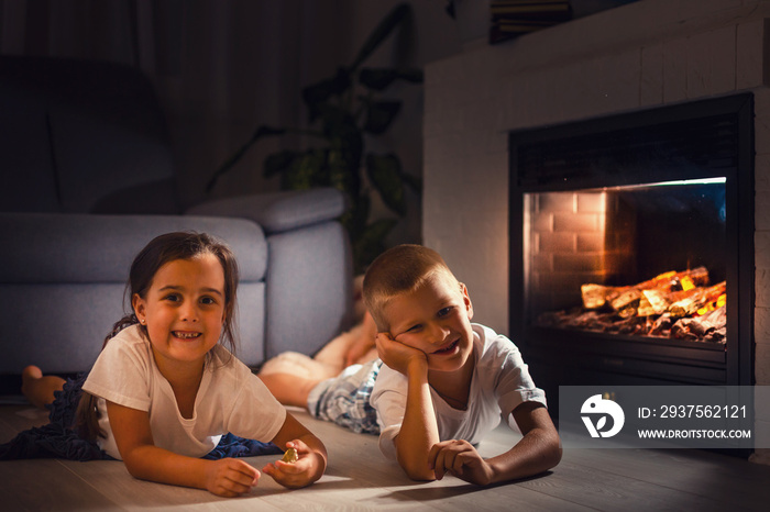 Portrait of a childs lying in front of fireplace