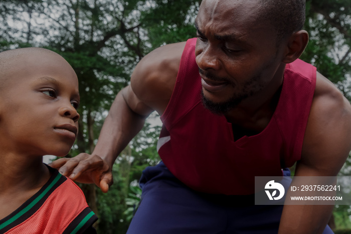 Boy and his father playing basketball