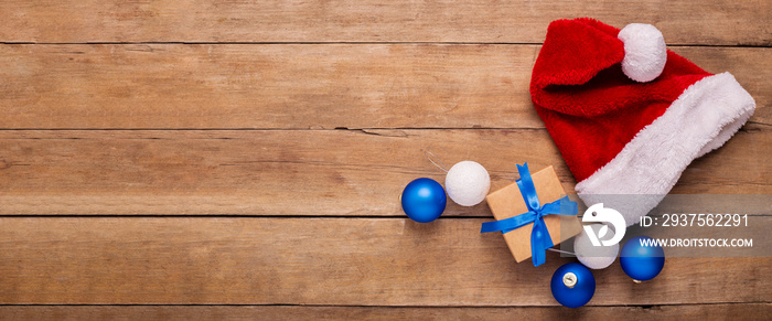 Santas hat on a wooden background. Concept for Christmas, New Year. Top view, flat lay. Banner