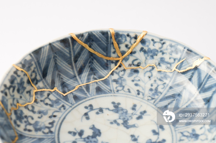 Japanese kintsugi ceramic bowl restored with real gold. Antique pottery kintsukuroi.