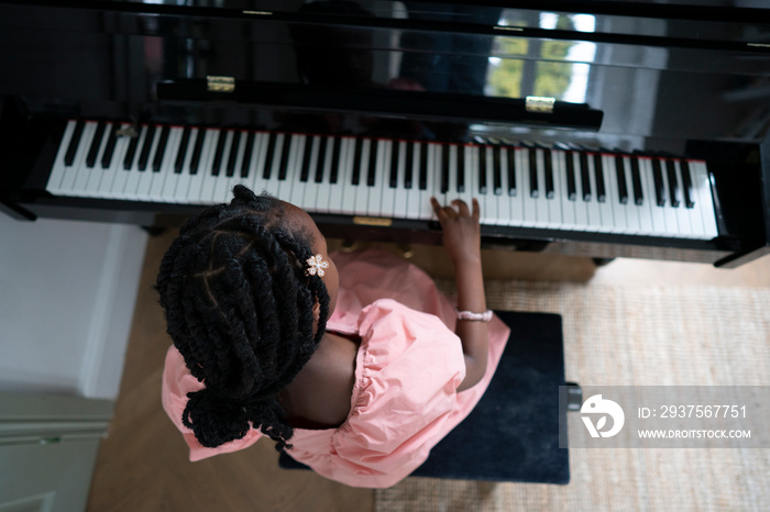 Girl (6-7) playing piano