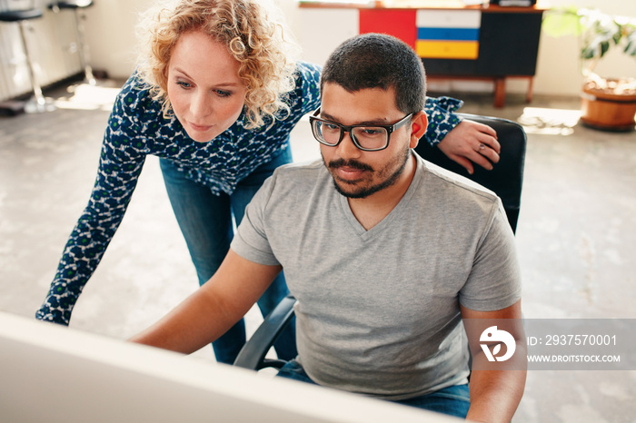 Graphic designers working on computer in office