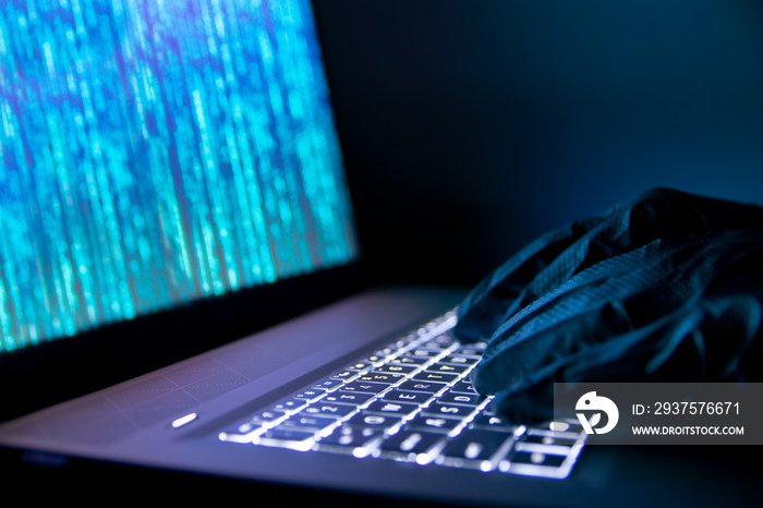 Hacker steals information using a laptop.