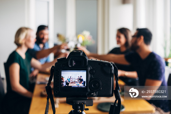 blogging: people toasting a front a recording photo camera