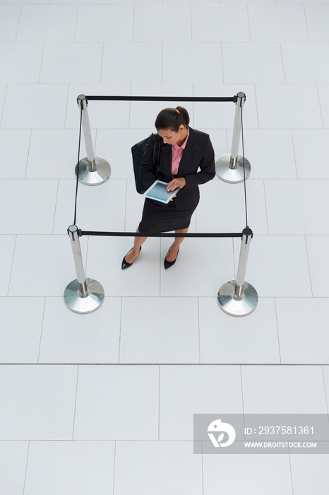 Businesswoman trapped in square stanchions